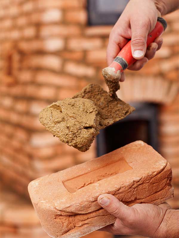 Masonry Restoration stock image - adding mix to brick for new tuckpointing - Rutland Chimney