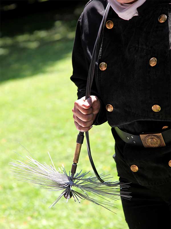 Technician with Sweeping Brush-stock image-Rutland Chimney
