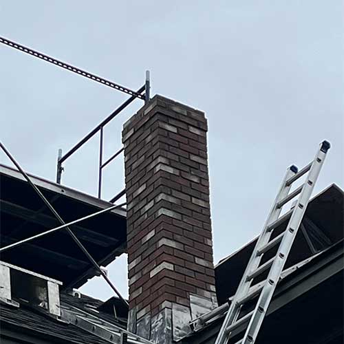 Masonry Repair - After - stock image with scaffolding and ladder against house - Rutland Chimney