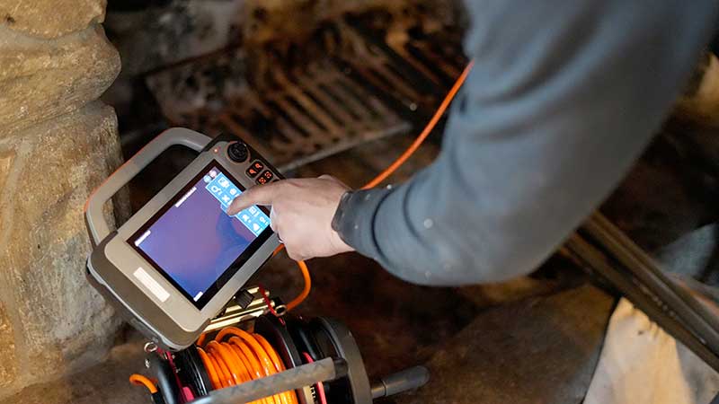 Rutland Chimney - Inspection Camera Inspection Camera in front of chimney with tech programming computer - Stock image - Rutland Chimney