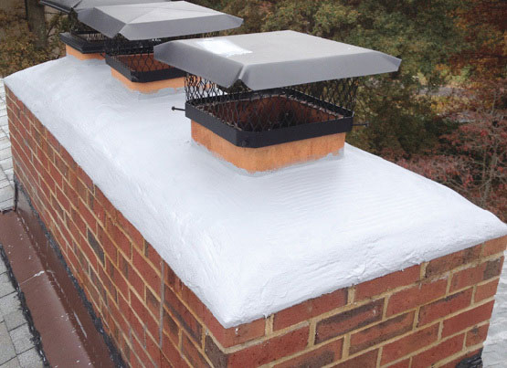 CrownTite-Chimney - crowns with two chimneys and snow on top - stock image - Rutland Chimney